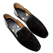 Top-down perspective shot of a pair of Christian Louboutin Varsi Espadon black suede espadrilles, showcasing the casual slip-on silhouette and tan leather interior lining