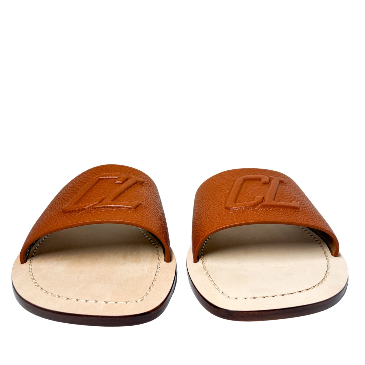 Front-facing perspective of the Christian Louboutin Varsicool leather sandals, showing the low-profile flat sole construction.
