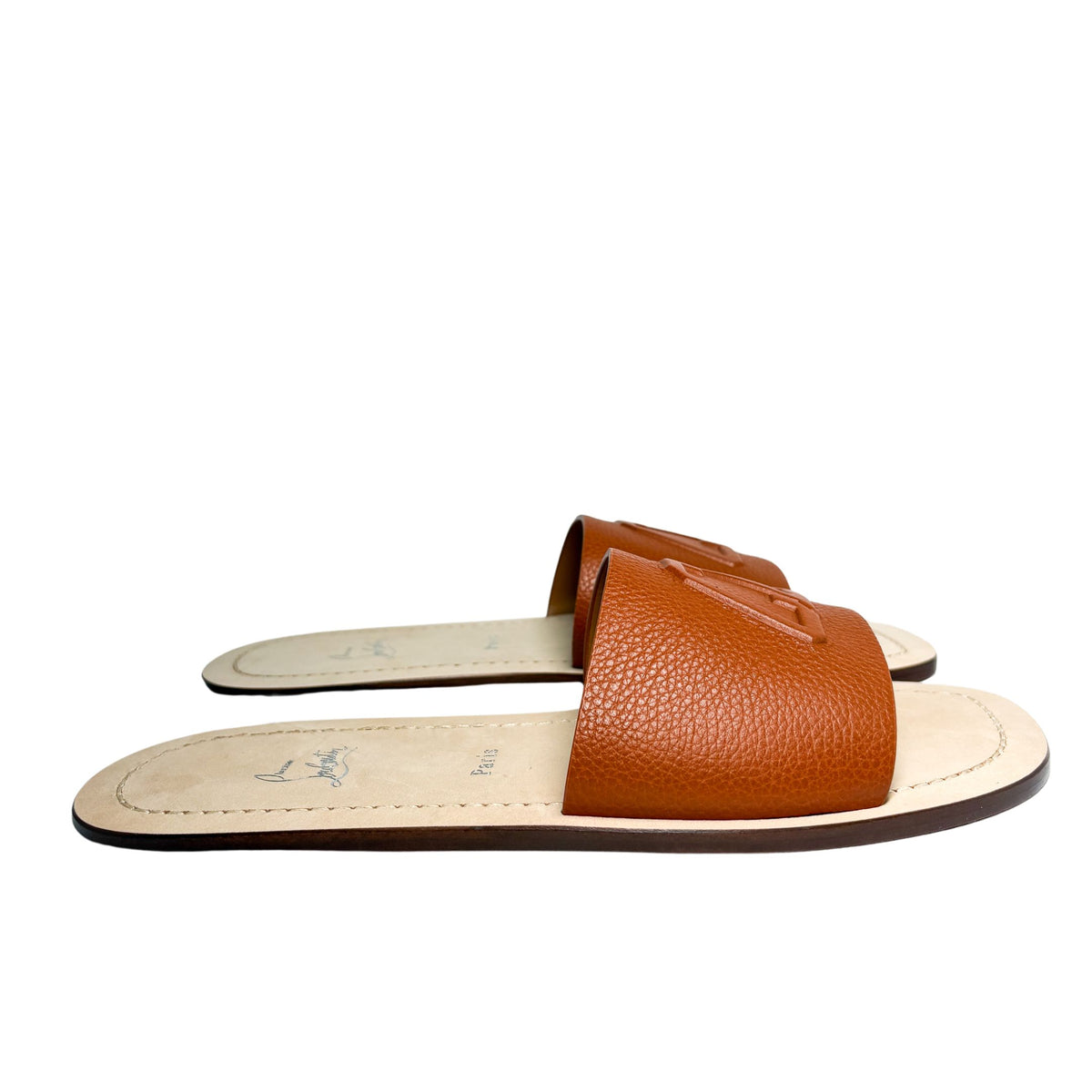Direct level side view of the Christian Louboutin Varsicool brown leather sandal, emphasizing the ultra-flat sole silhouette