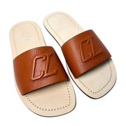 Top-down parallel studio shot of a pair of Christian Louboutin Varsicool brown leather slide sandals side-by-side.