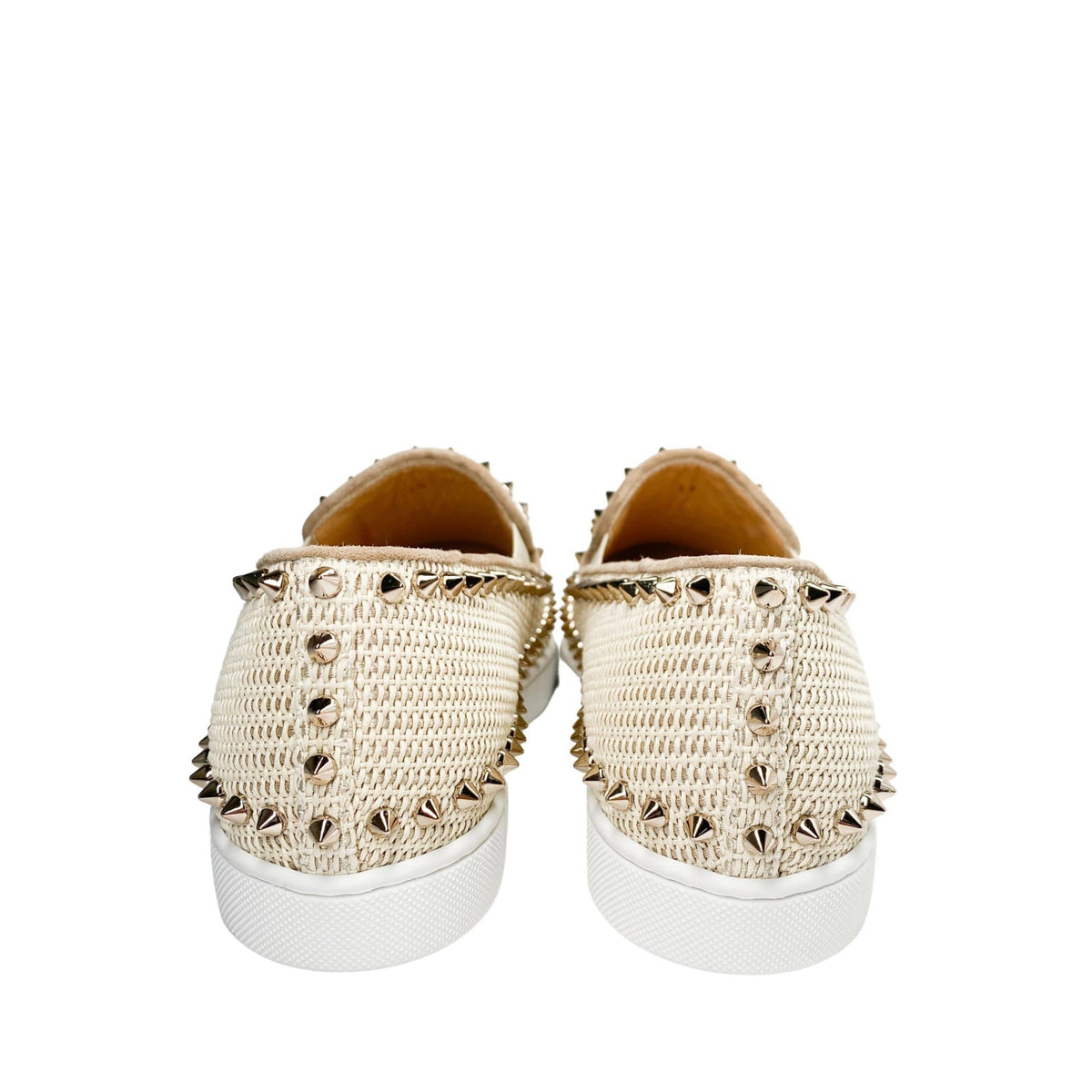 Rear view of a pair of Christian Louboutin Boat woven espadrilles in pink from behind, showcasing the clean heel counters and metallic spike accents.