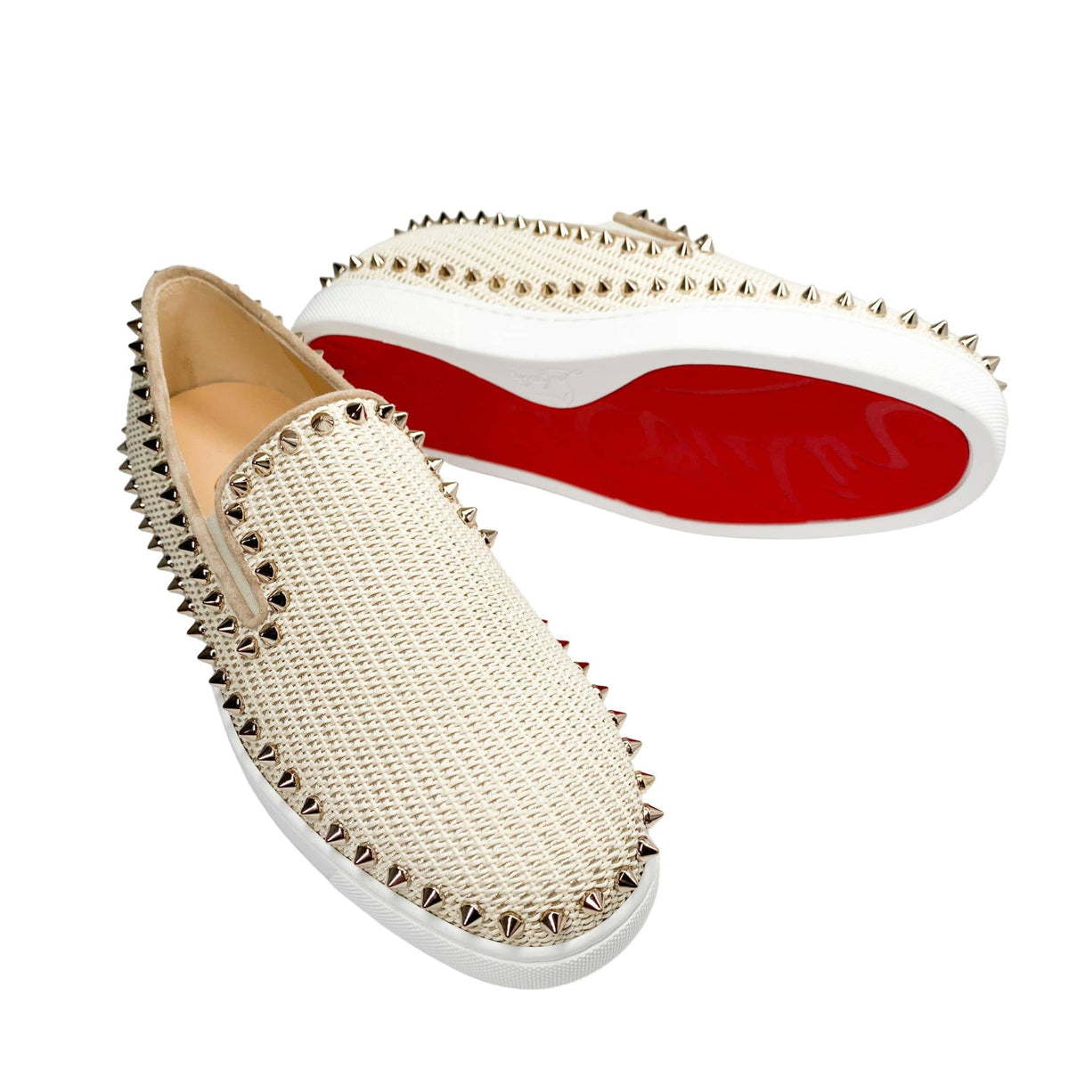 Angled studio shot of a pair of pink Christian Louboutin Boat woven espadrilles, highlighting the classic jute-wrapped midsole texture.