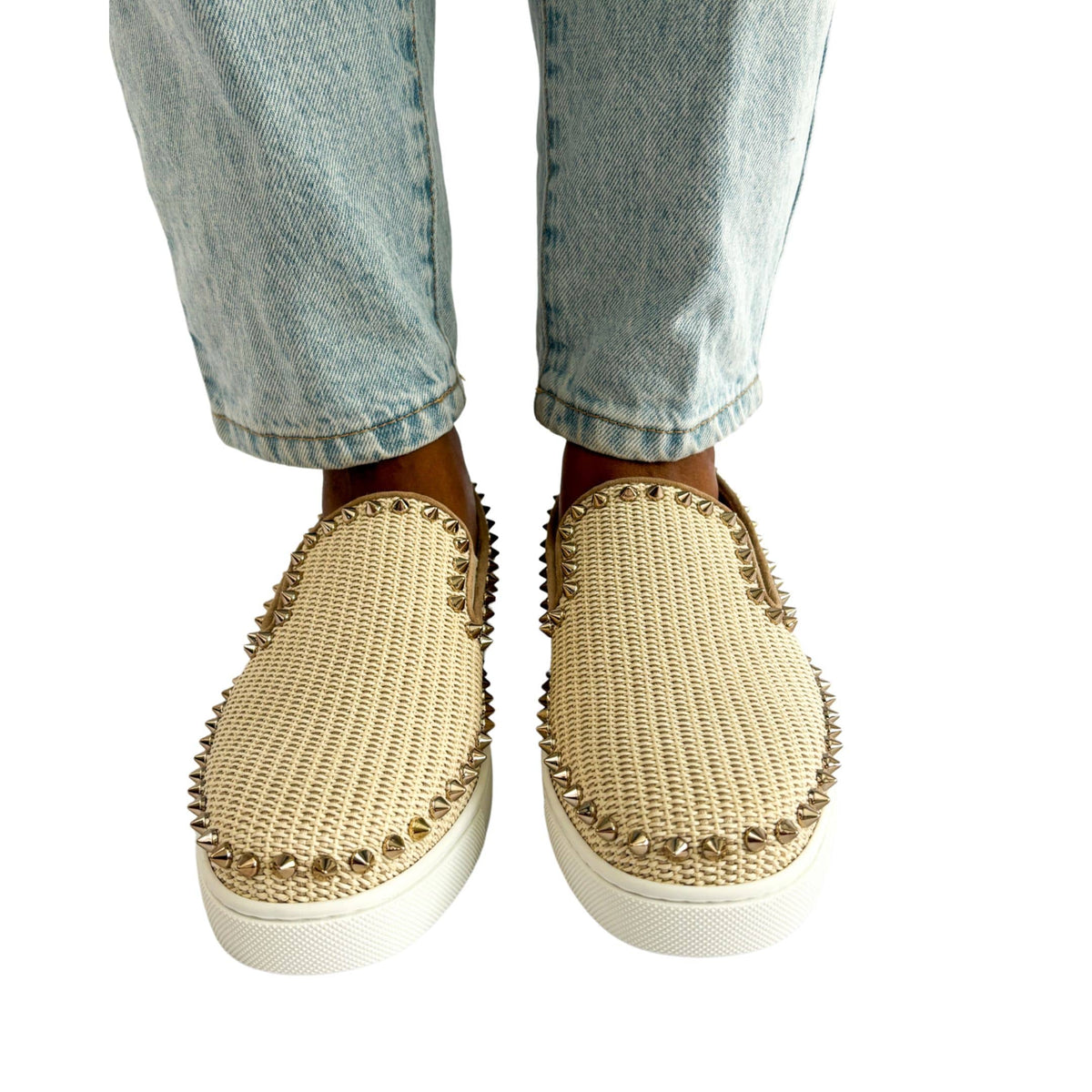 Symmetrical front angle on-foot view of a model wearing the pink canvas Christian Louboutin studded slip-on espadrilles.