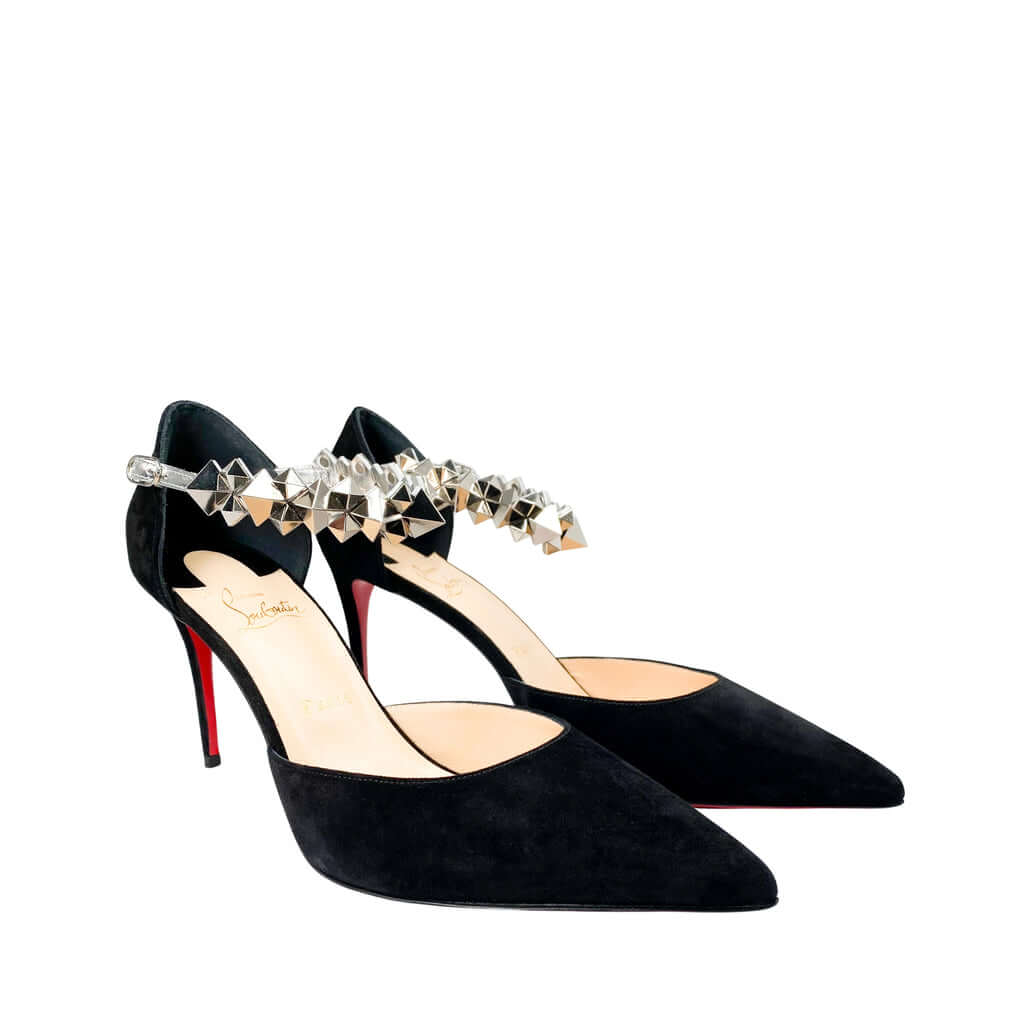 Side perspective studio shot of a pair of Christian Louboutin Planet Chic 90 black suede pumps positioned together against a white background.