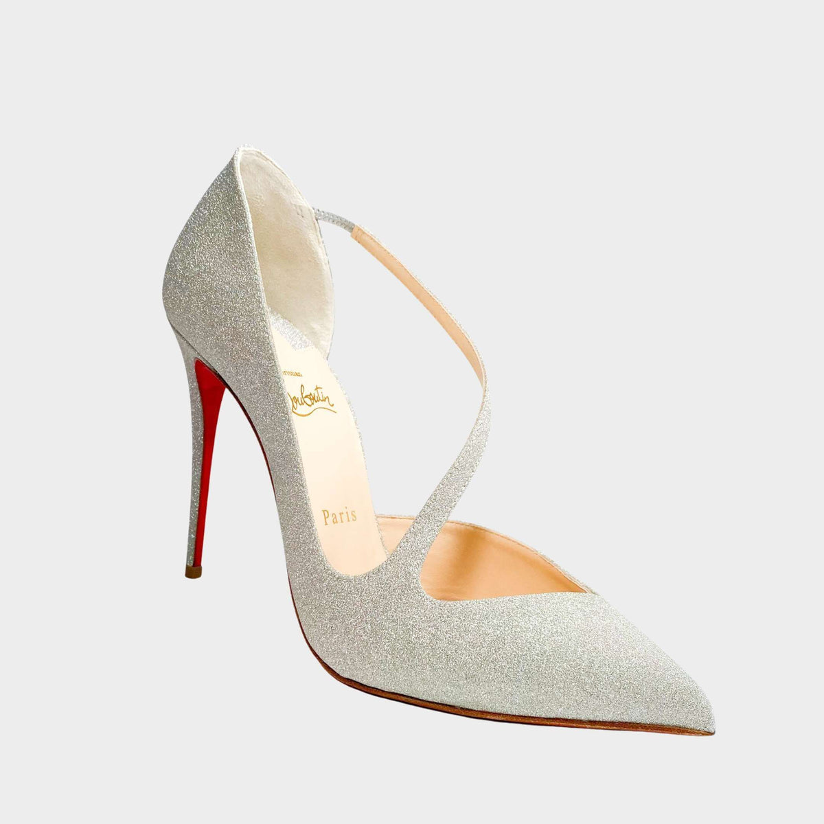 Side profile close-up of a Christian Louboutin Jumping Glitter 100 pump, showcasing the shimmering textured fabric upper and signature scarlet red lacquer stiletto heel.