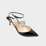 Side profile close-up of a Christian Louboutin Levita 55 pump in black embossed leather, showcasing the transparent PVC upper, pyramid-studded ankle strap, and kitten heel.