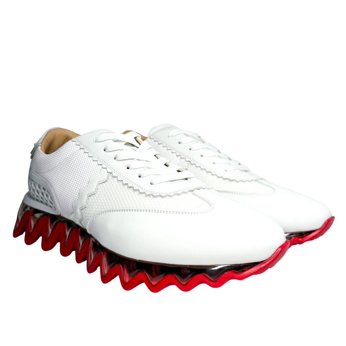 Angled side shot of the white Christian Louboutin Loubishark trainers, showcasing the sculpted mesh panels and clean white laces.
