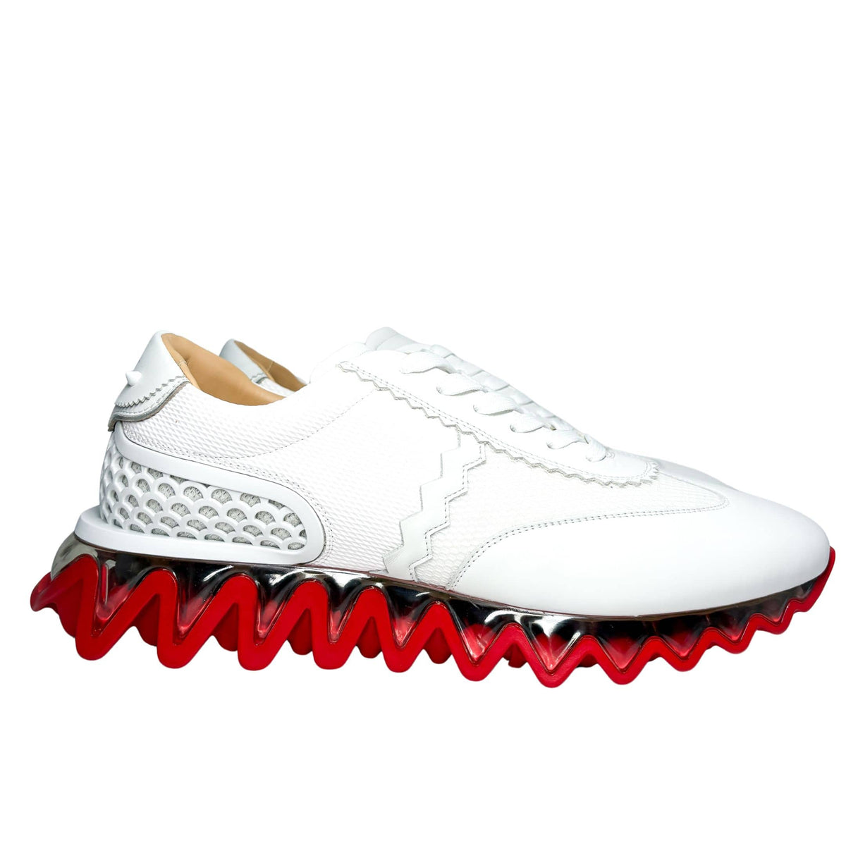 Full side perspective shot of a single Christian Louboutin Loubishark sneaker in white leather, showcasing the aggressive sole silhouette.