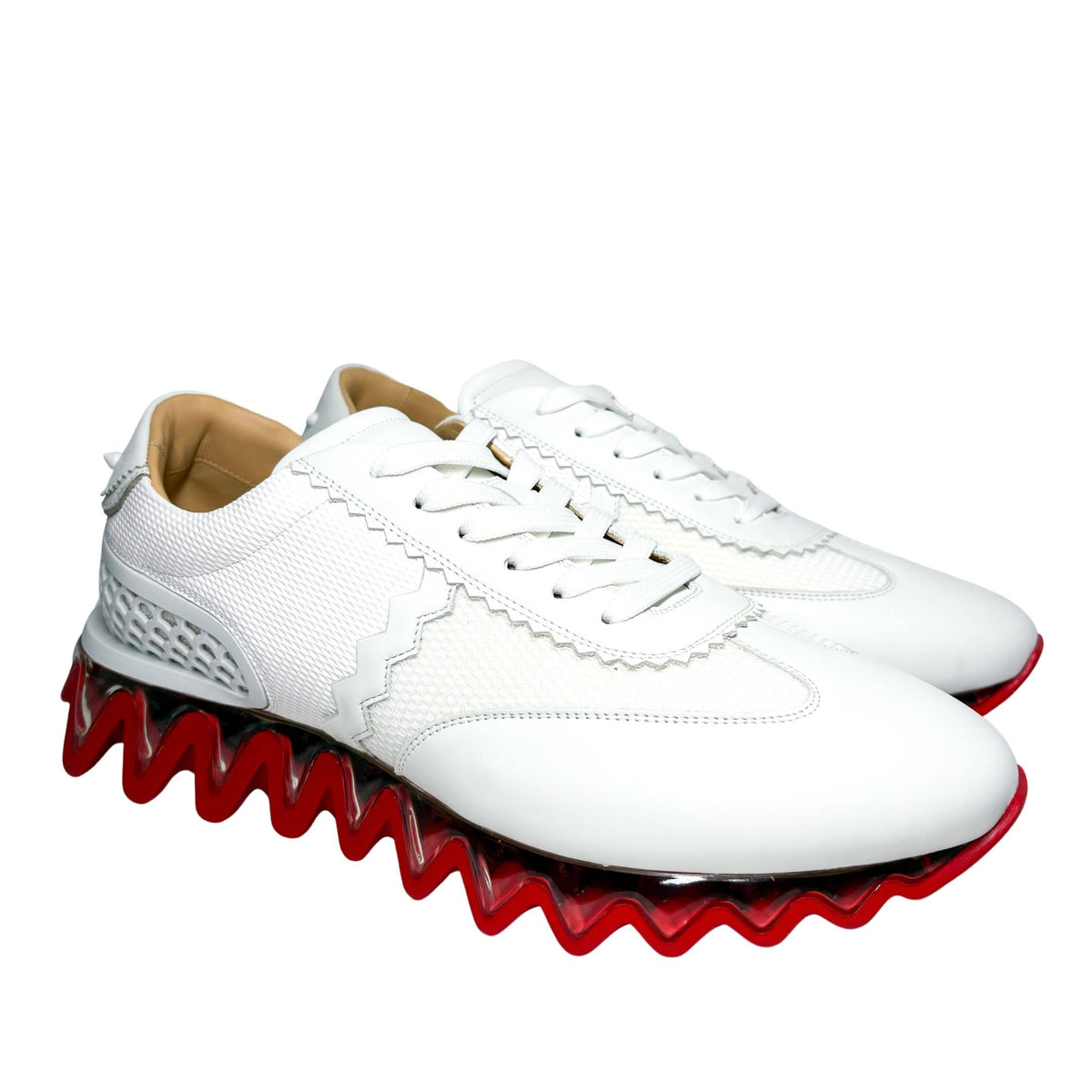 Right side three-quarter profile of the white Loubishark sneaker, highlighting the heavy tread structure and sport-luxury design.