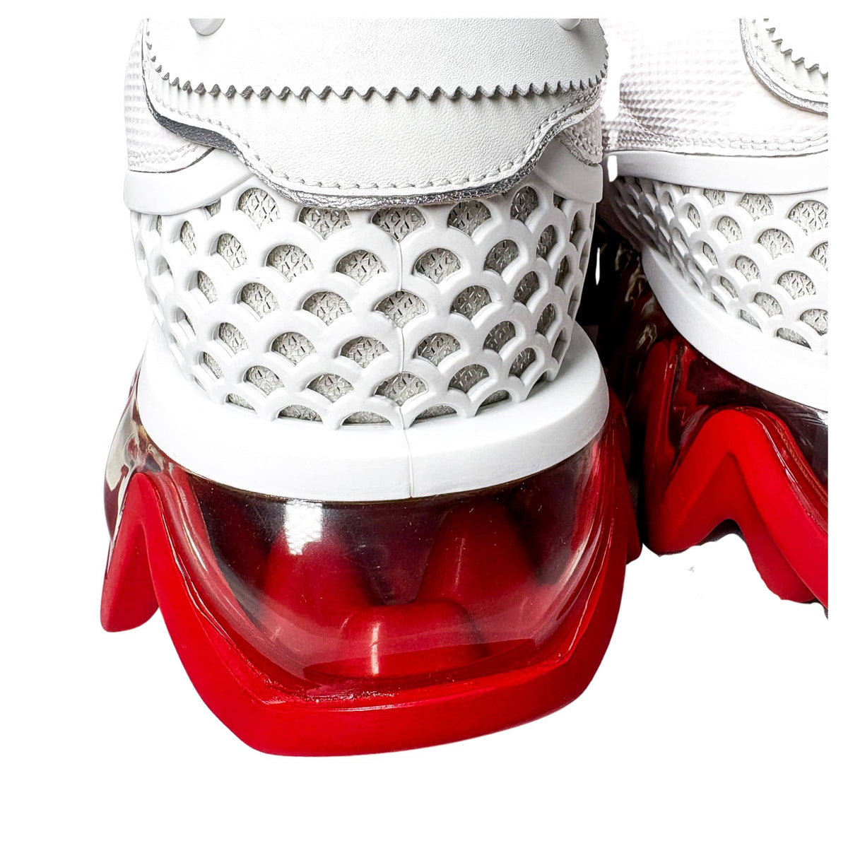 Close-up rear shot of a single Christian Louboutin Loubishark heel counter, showcasing the white mesh details and structural pull tab.