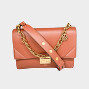 Front view of the luxury Fendi Kan U shoulder bag in brown calf leather, highlighting its gold-tone chain trim and geometric flap.