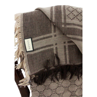 Close-up of a Gucci GG monogram scarf featuring the iconic logo design and luxury finish