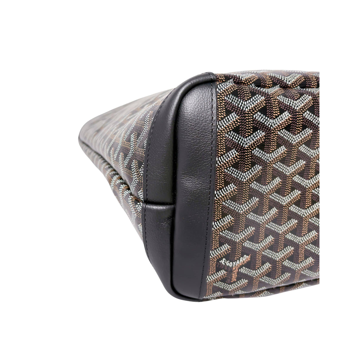 Close-up of Goyard Artois MM tote bag showing reinforced black leather bottom corner construction.