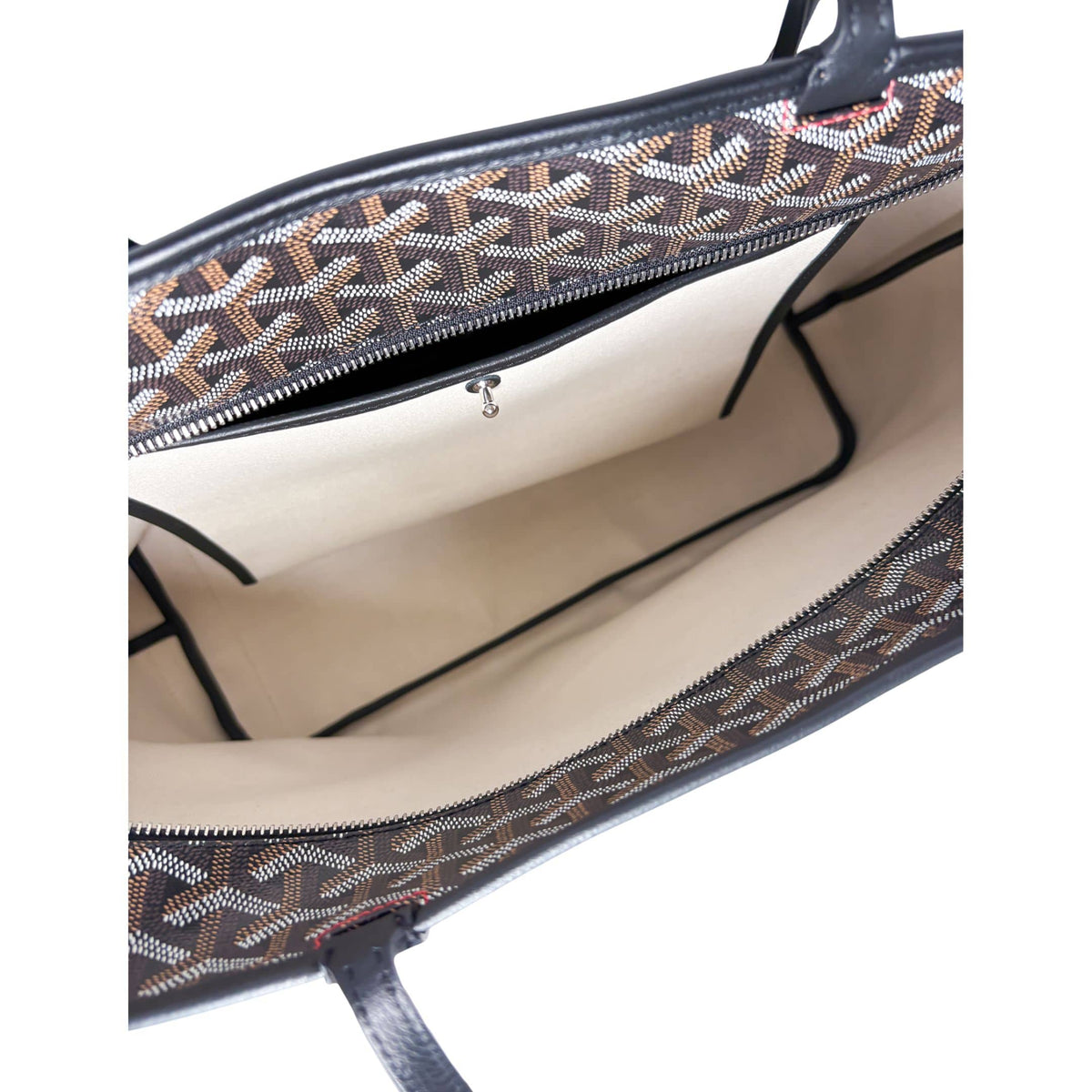 Interior view of Goyard Artois MM tote bag displaying spacious canvas lining and zip pocket.