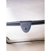 Interior detail view of Goyard Artois MM handbag showing leather logo tab and zip pocket closure.