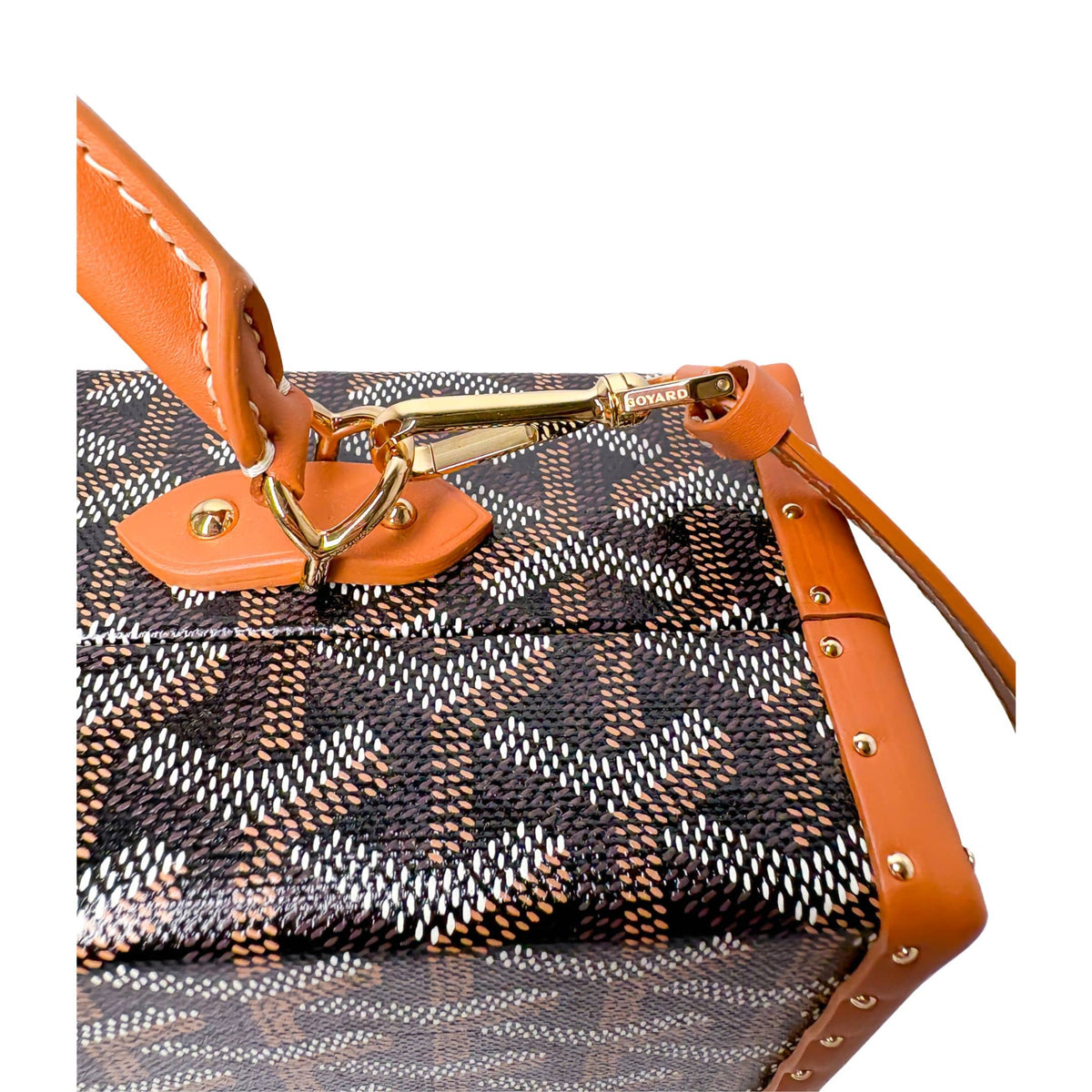 Close-up of Goyard Grand Hôtel Trunk Bag featuring tan leather shoulder strap and silver-tone metallic hardware.