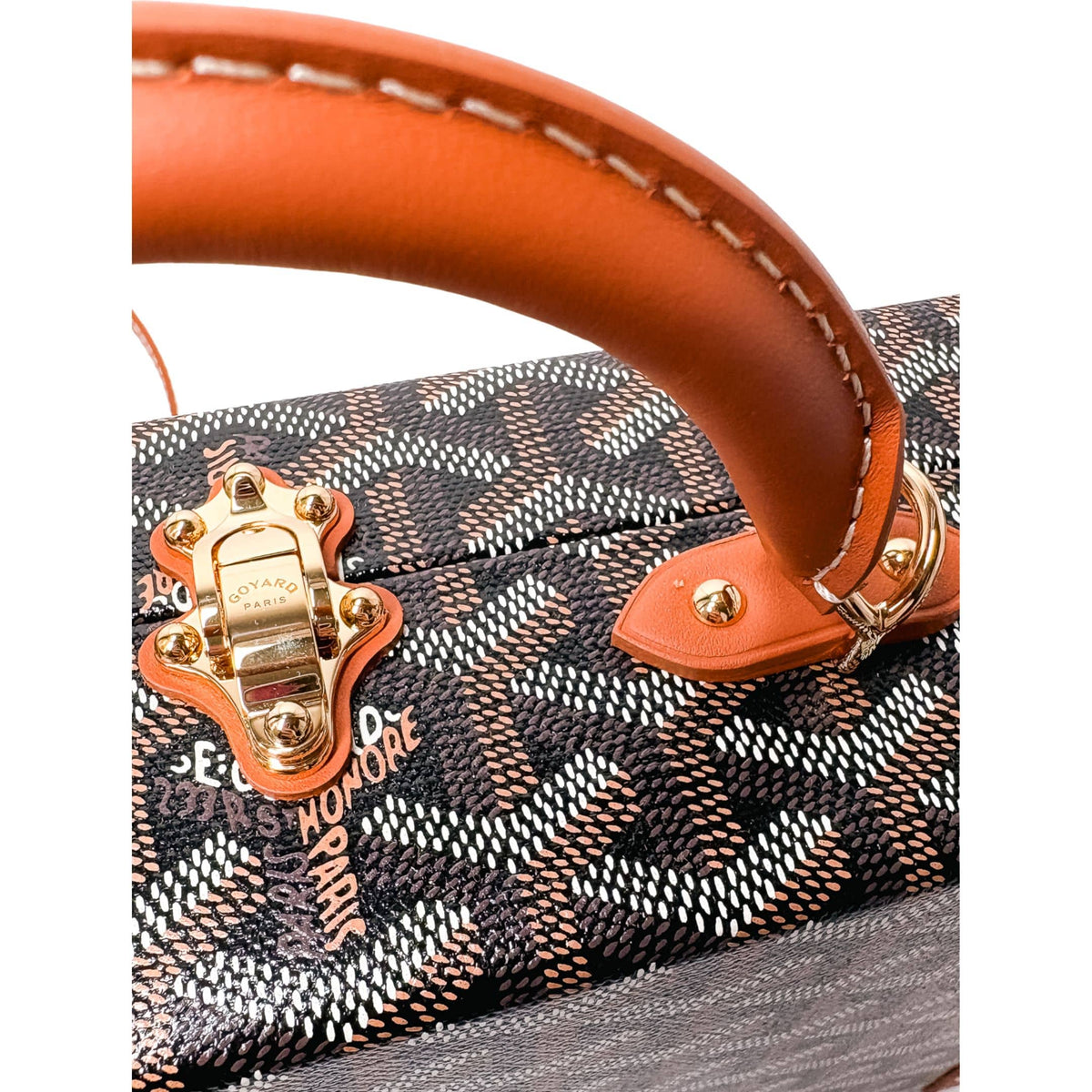 Side profile view of Goyard Grand Hôtel Trunk Bag showing structured shape and leather corner trim.
