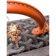 Side profile view of Goyard Grand Hôtel Trunk Bag showing structured shape and leather corner trim.