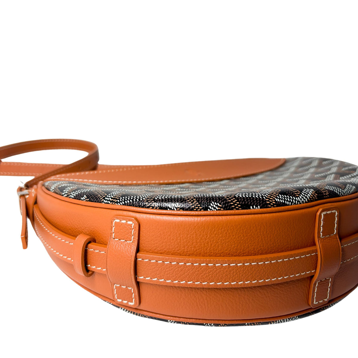 Side profile view of Goyard Hirondelle crossbody bag showing structured depth and tan leather piping.