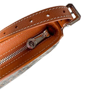 Close-up view of Goyard Hirondelle bag adjustable tan leather shoulder strap and metallic buckle.