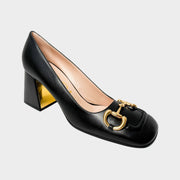 Side profile view of Gucci Baby Pump in black leather showcasing structured 75mm block heel with gold-plated accent.