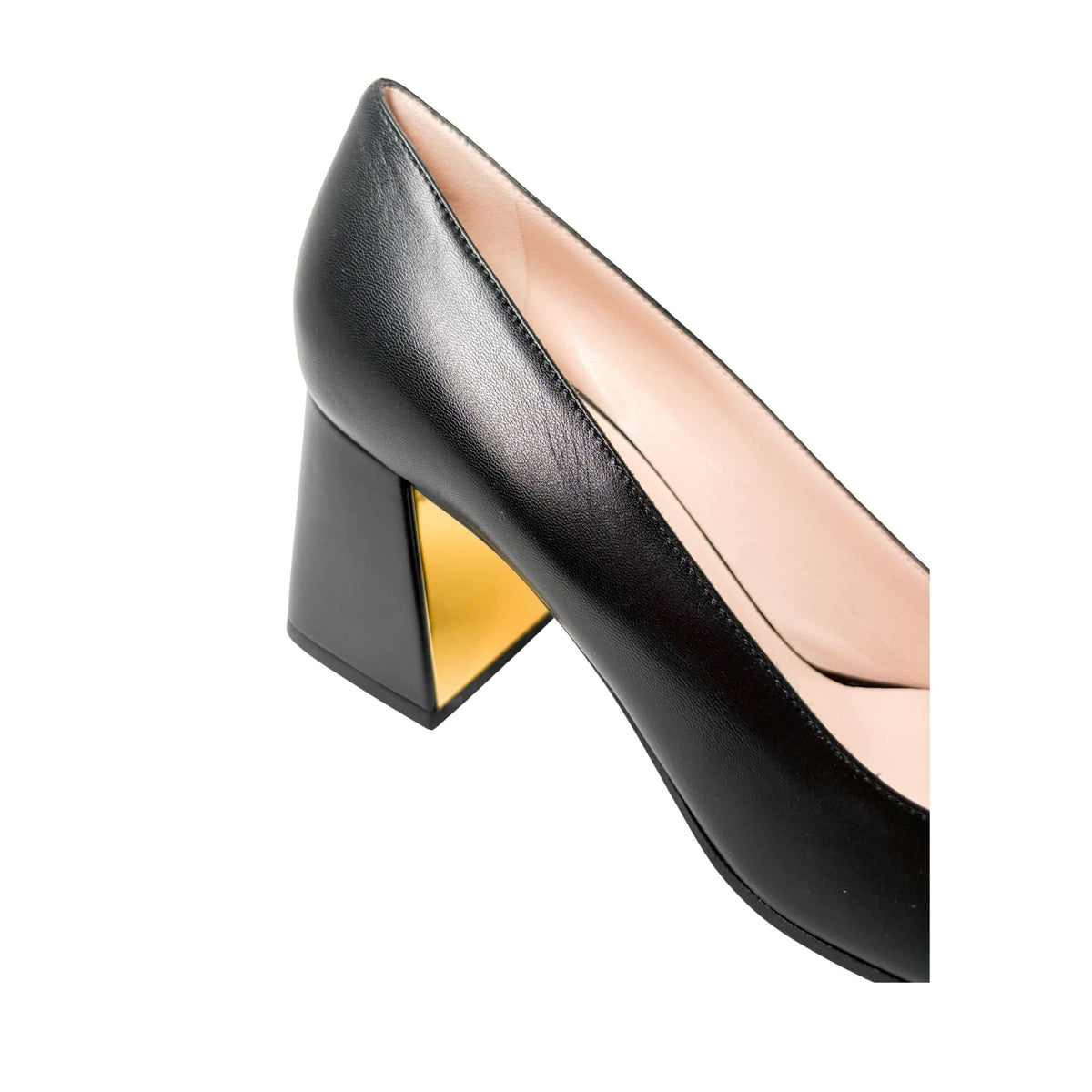 Detailed side view focusing on the 75mm block heel of the Gucci Baby Pump, highlighting the reflective gold-plated accent on the inner heel curve.