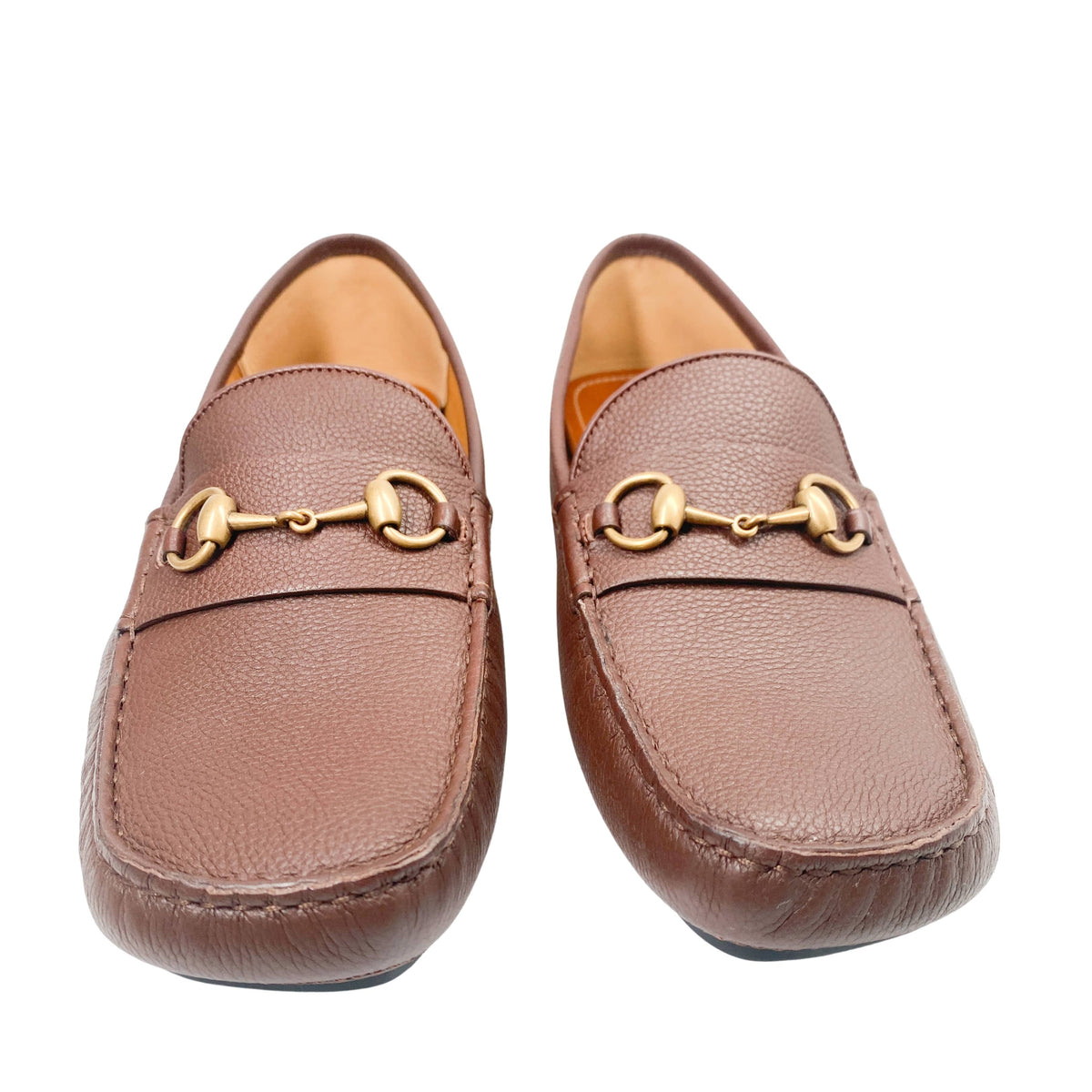 Front view of a pair of brown leather Gucci Horsebit loafers side-by-side on a white background.