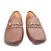 Front view of a pair of brown leather Gucci Horsebit loafers side-by-side on a white background.