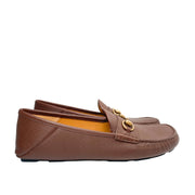 Side profile view of Gucci men's brown leather Horsebit loafer showing driver tread outsole.