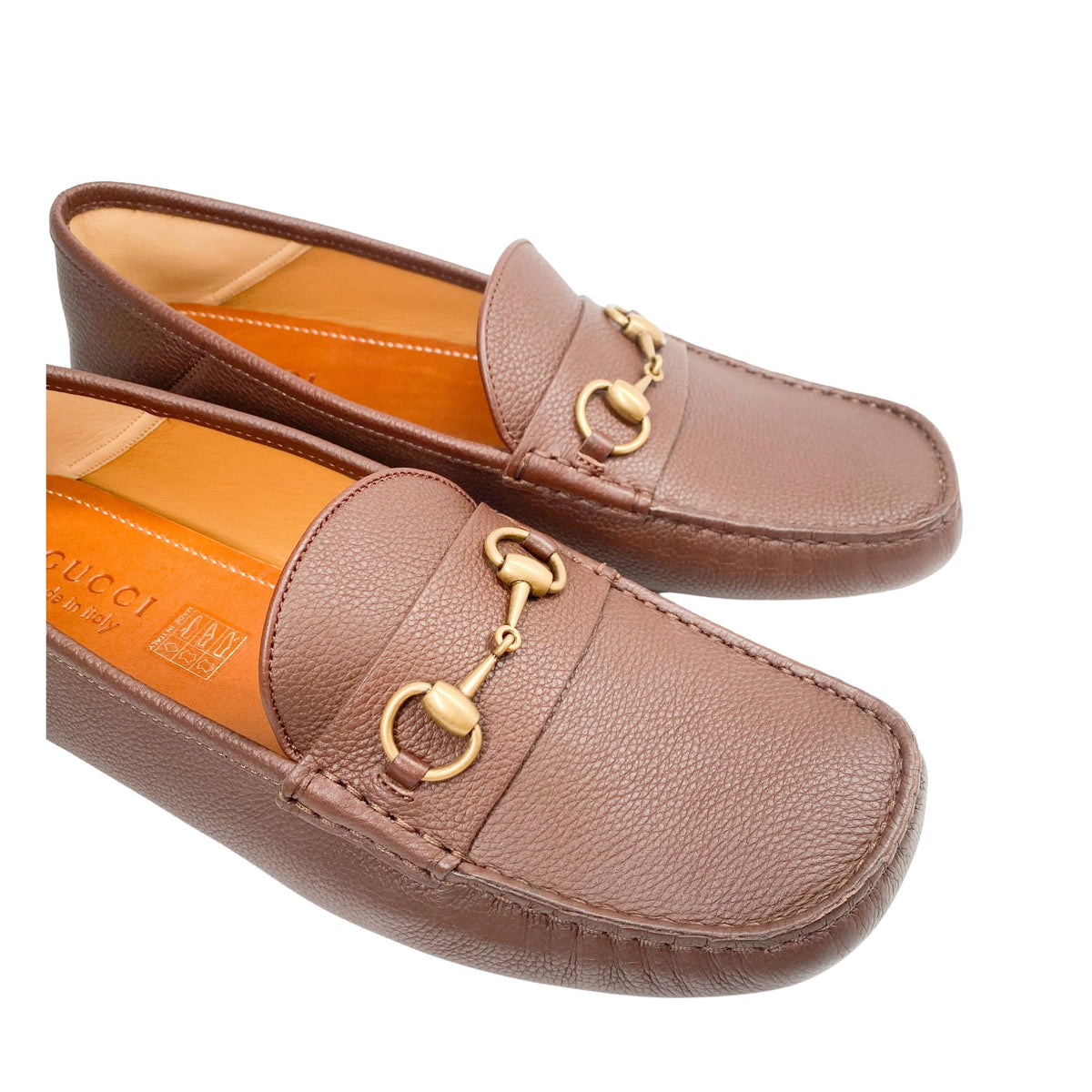 Elevated three-quarter view of brown Gucci Horsebit loafers showcasing soft leather uppers.