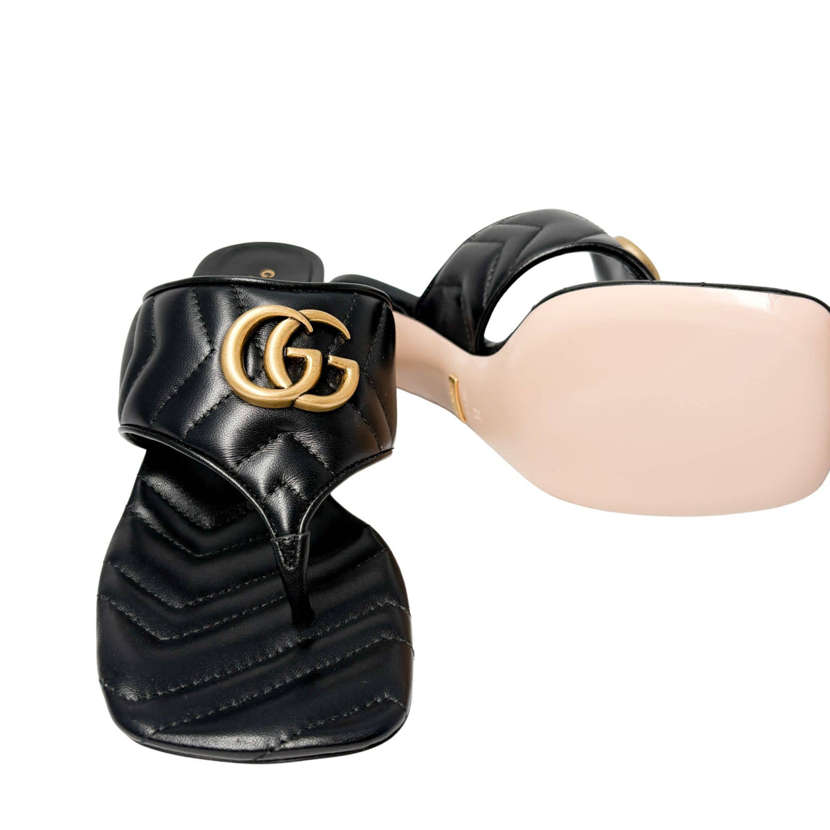 Detailed close-up profile view of the black Gucci Charlotte sandal, highlighting the smooth beige leather lining underneath the quilted strap.