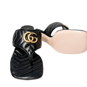 Detailed close-up profile view of the black Gucci Charlotte sandal, highlighting the smooth beige leather lining underneath the quilted strap.