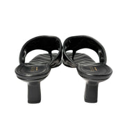 Rear view of the black Gucci Charlotte kitten heel sandals from behind, focusing on the structured heel counters and clean stitching.
