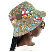 Angled view of Gucci x Disney Donald Duck GG monogram bucket hat showing crown shape and brown leather trim detail