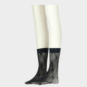 On-leg view of black Gucci GG net stockings made from fine Italian mesh featuring the iconic all-over GG monogram pattern.