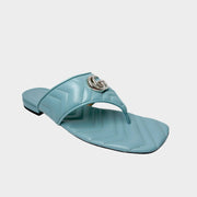 Side profile view of a Gucci Marmont Charlotte slide sandal in Foggy Sky blue-grey leather, featuring a quilted chevron pattern and a silver-toned double G logo.