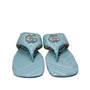 Symmetrical front view of a pair of Gucci Marmont Charlotte slide sandals side-by-side, showcasing the open toe design and silver double G hardware.