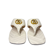 Symmetrical front-facing studio view of a pair of white Gucci Marmont Charlotte sandals side-by-side, showcasing the open toe design.