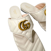 Close-up three-quarter view of the white Gucci Charlotte leather sandal, highlighting the quilted chevron pattern and flat sole profile.