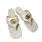Top-down perspective of a pair of off-white Gucci Charlotte sandals, showing the branded leather insoles and parallel layout.