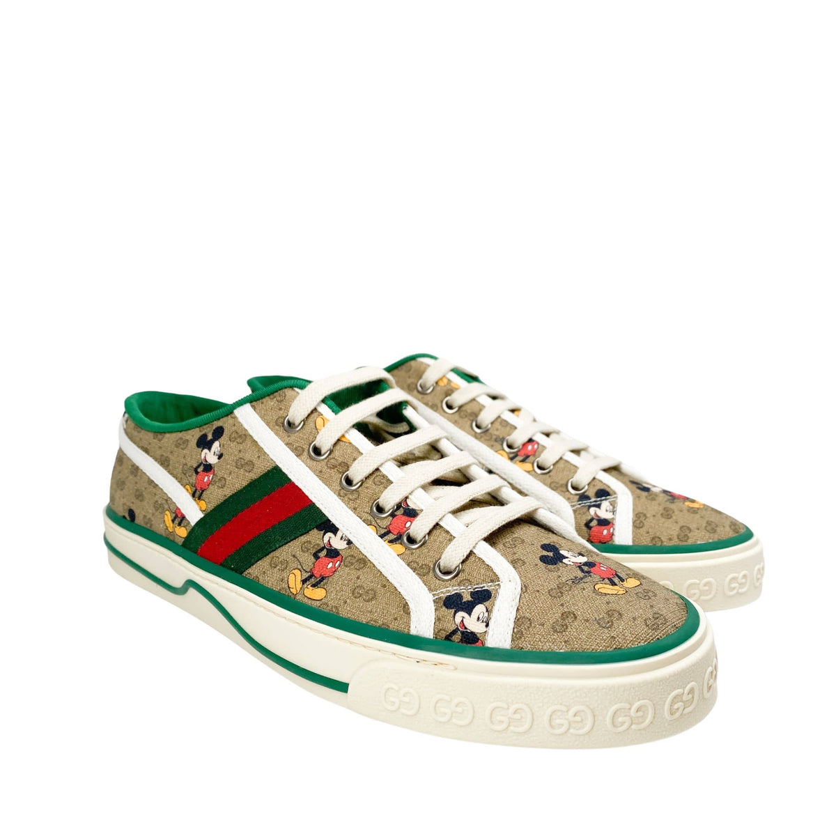 Three-quarter view of Gucci x Disney Mickey Mouse GG Supreme canvas trainer with red accent stripe on sole.
