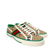 Three-quarter view of Gucci x Disney Mickey Mouse GG Supreme canvas trainer with red accent stripe on sole.