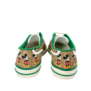Close-up view of Mickey Mouse printed graphic on GG monogram canvas of Gucci 1977 sneaker.