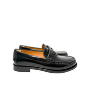 Side profile view of Gucci Millennial Ribot black leather loafer showing low flat heel and refined leather outsole.