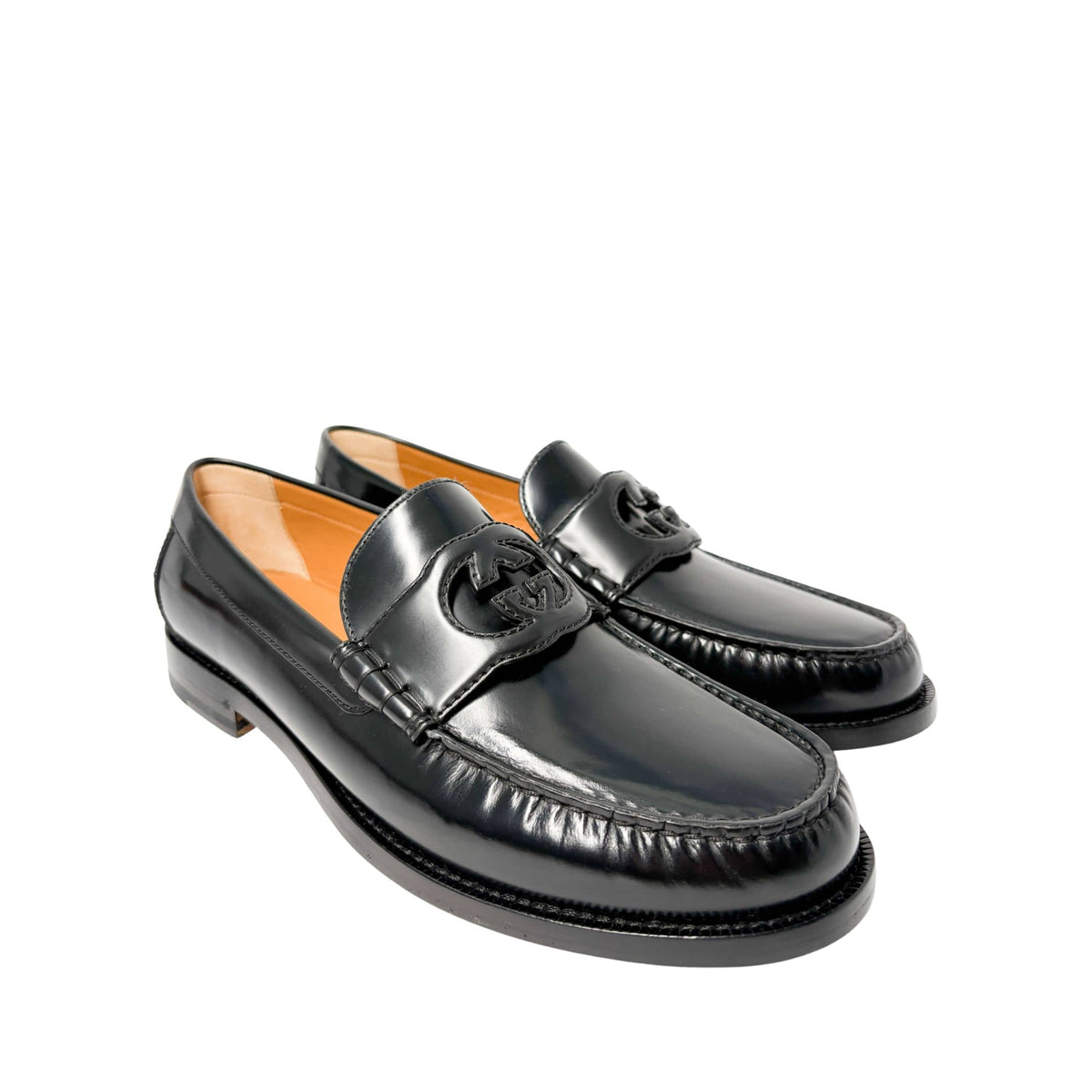 Front perspective view of Gucci Millennial Ribot black leather loafers side-by-side showcasing round toe box design.
