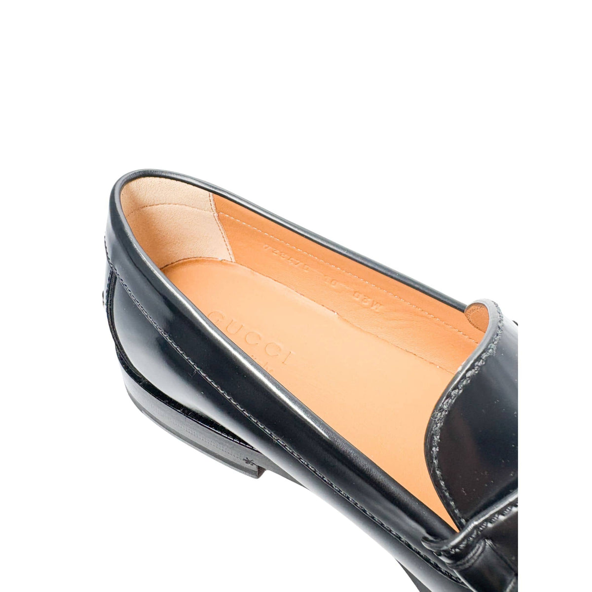 Close-up view of Gucci Millennial Ribot black leather loafer opening showing cushioned tan leather lining and inner collar.