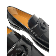 Overhead three-quarter angle of Gucci Millennial Ribot black leather loafers highlighting soft upper leather and classic shoe profile.