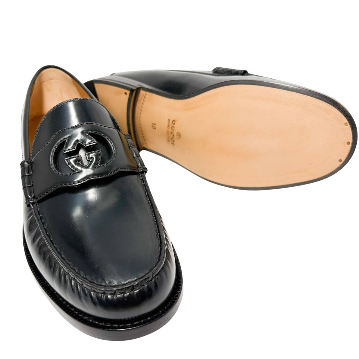 Front perspective shot of Gucci Millennial Ribot black loafer displaying the polished leather upper and leather sole construction.