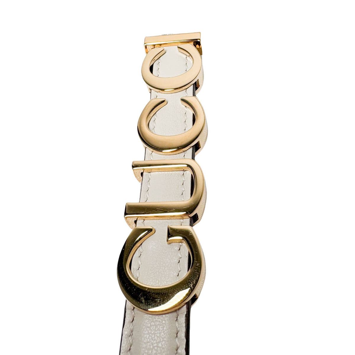 Close-up of Gucci Plutone Belt in white - elegant leather belt with polished metal buckle and timeless appeal.