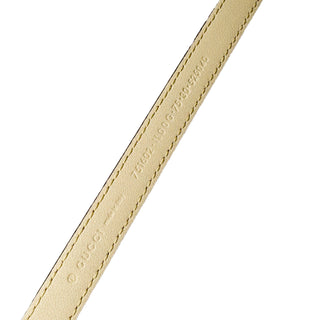 Close-up of Gucci Plutone Belt in gold - sophisticated designer belt with polished finish and iconic Gucci design